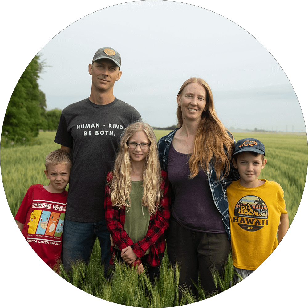 Jason Rempel and family standing in a wheat field