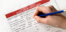Hand filling out a form