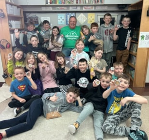 Volunteer with students during Canadian Agricultural Literacy Month